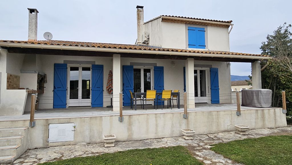 La façade aux volets bleus et sa terrasse